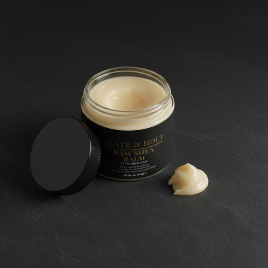 Jar of Raw Shea Balm with a black lid on a dark background