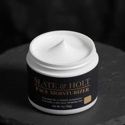 Jar of Slate & Holt face moisturizer on a dark background
