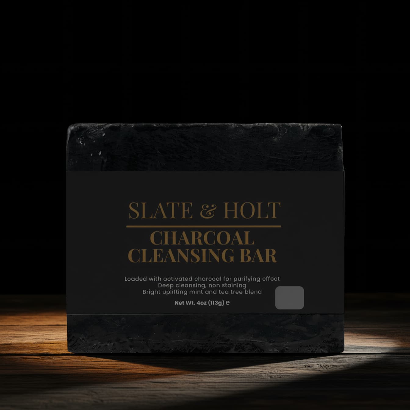 Black soap bar with 'Slate & Holt' branding on a dark background