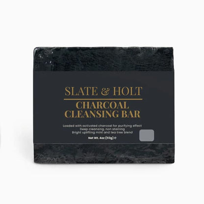 Black charcoal cleansing bar with 'Slate & Holt' branding on a white background