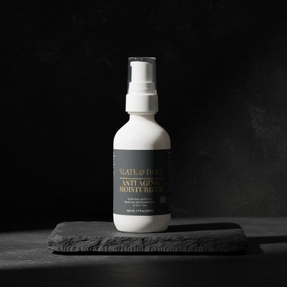 White bottle of anti-aging moisturizer on a dark background