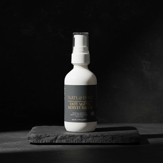 White bottle of anti-aging moisturizer on a dark background