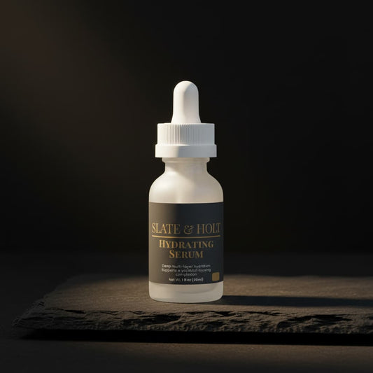 Bottle of Slate & Holt Hydrating Serum on a dark background